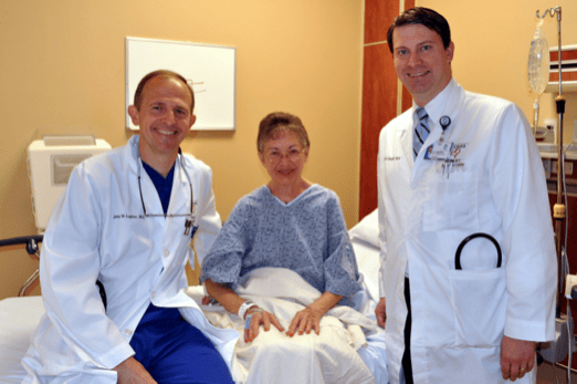 Louise Condron, center, recipient of Athens’ first S-ICD implantable cardiac defibrillator, poses with the implanting cardiologist John Layher, M.D., left, and her primary cardiologist, Clay Chappell, M.D., right, prior to her procedure Monday.