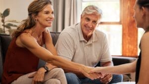 A lively boomer couple sitting with a funeral home director to finalize arrangements and end of life plans early.
